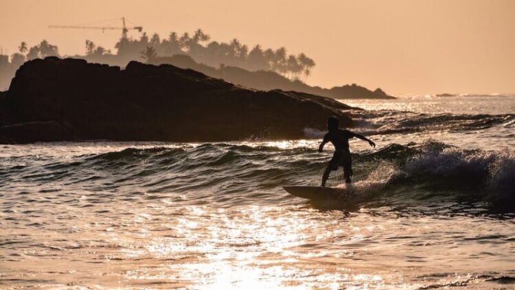 surfer riding a wave in Weligama