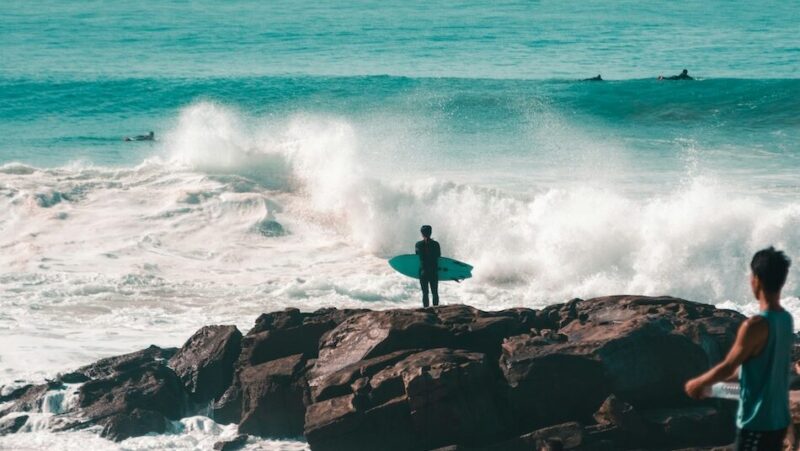 surfer standing over the surf in Taghazout Morocco