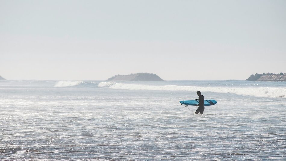 surfer walking in from the surf Tamraght
