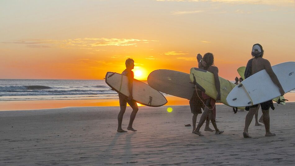 surfers walking on the beach in Costa Rica