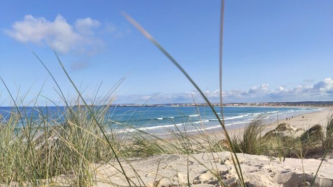 Peniche beach with blue water and sunny skies