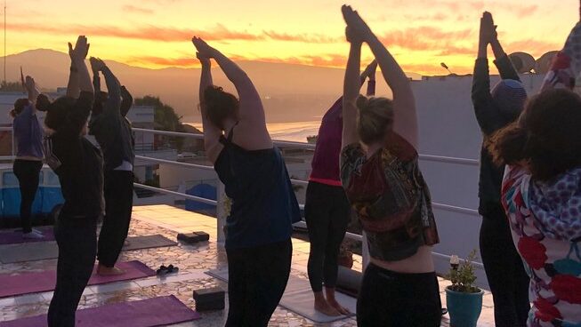 People doing yoga at sunset with Surf Coast Morocco