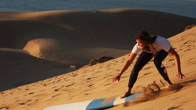 a girl sand boarding in Taghazout
