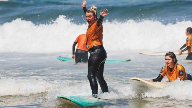 a learner surfer standing up on a wave