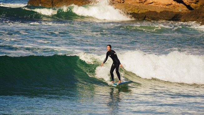 a surfer learning on a wave in Tamraght
