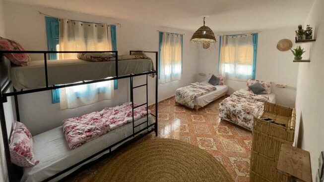 dorm room with bunk beds and single beds at Sunny Wave Taghazout