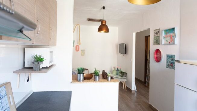 inside with kitchen and table at Marias Hostel & Surf