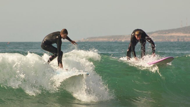 learner surfers on a wave in Taghazout