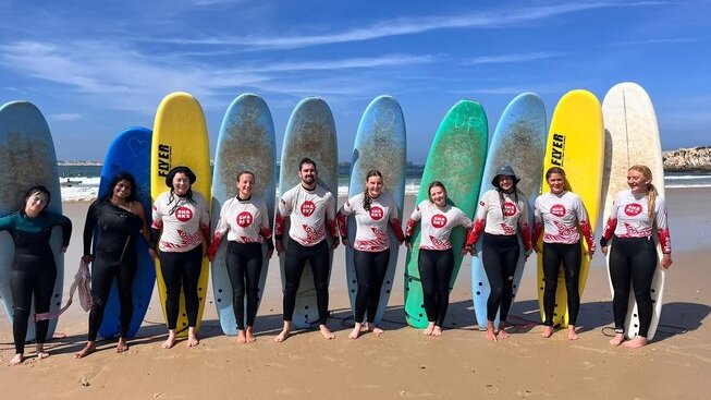 learner surfers on the beach with Peniche Surf Lodge