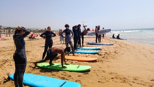 learner surfers practicing on the beach