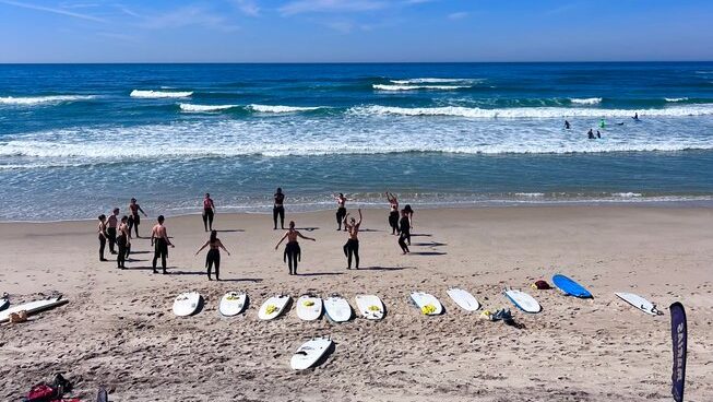 learner surfers warming up with Marias Hostel & Surf