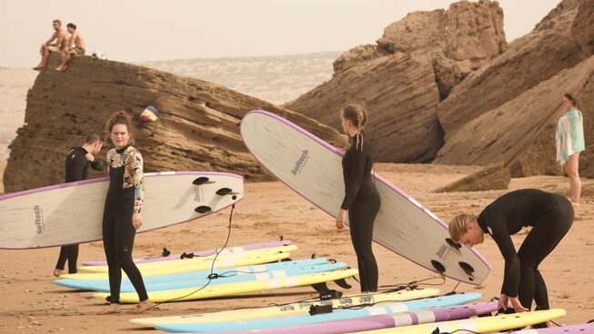 surfers getting ready on the sand in Taghazout with Sunny Wave Taghazout
