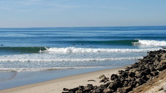 surfers ridng waves in Porto
