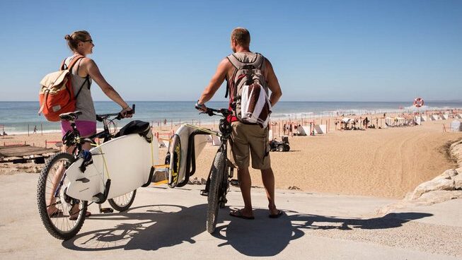 two people with bikes and surfboards